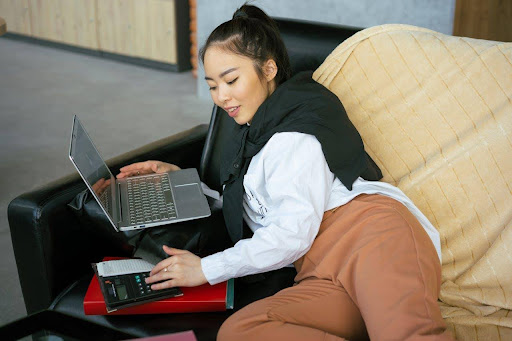 Woman working from her couch at home
